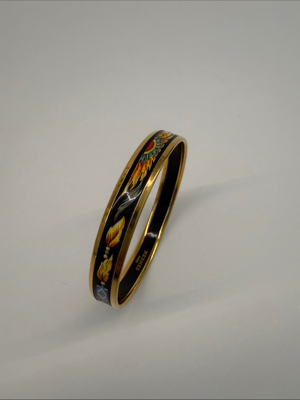 Hermes Black Enamel Bracelet with Gold Trim and Floral Motif